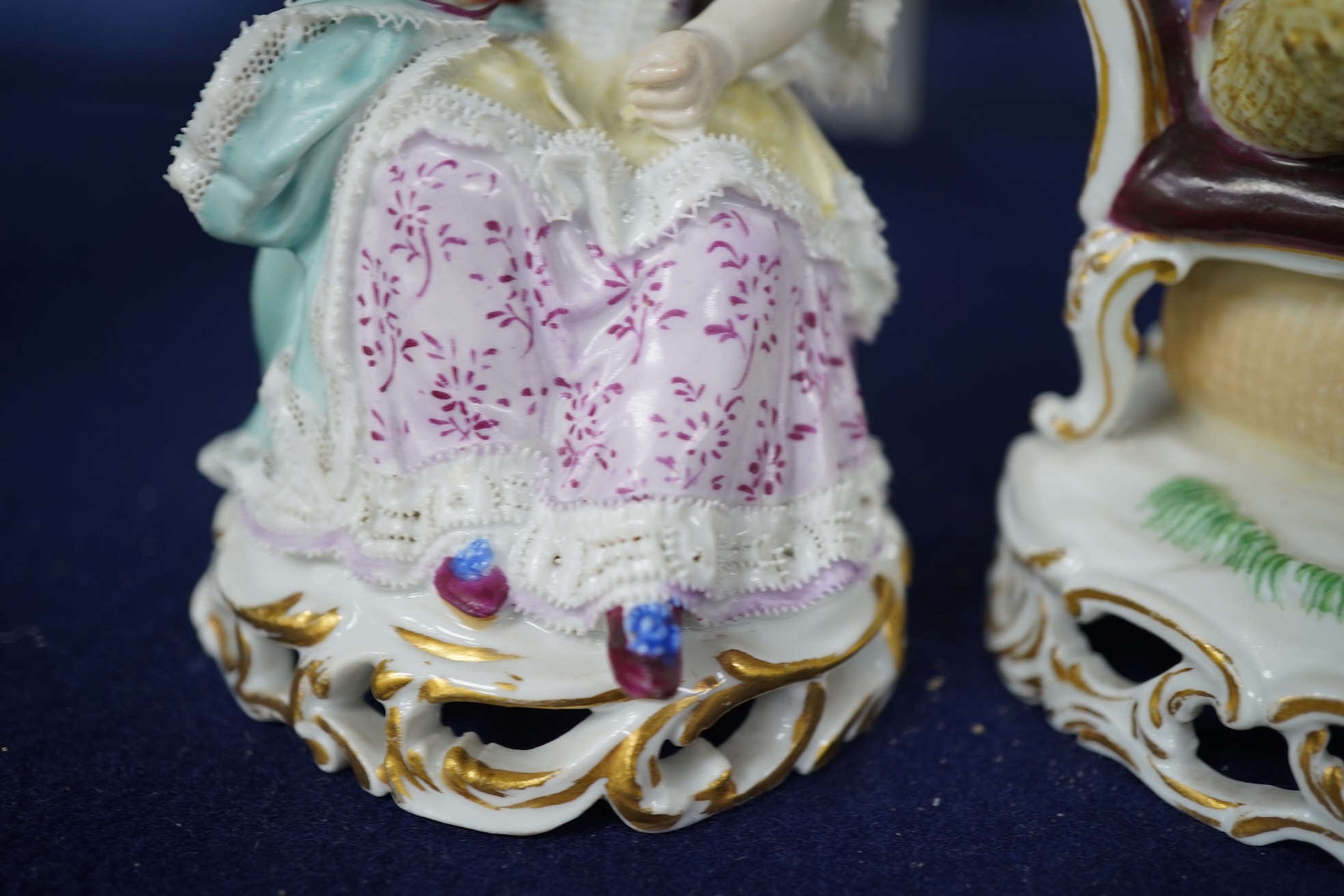 A pair of 19th century Meissen figures of a girl holding a shell and a boy holding a book, in size model number 628, tallest 13cm